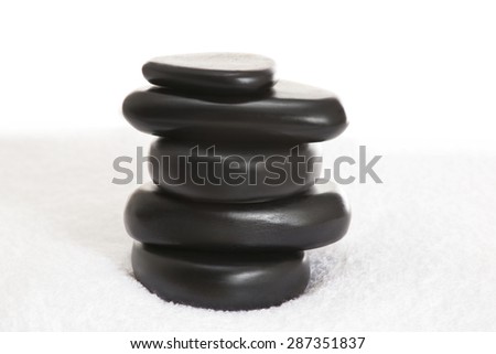 Stacked massage stones on a towel
