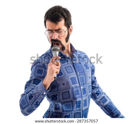 Vintage young man singing with microphone  Royalty-Free Stock Photo #287357057
