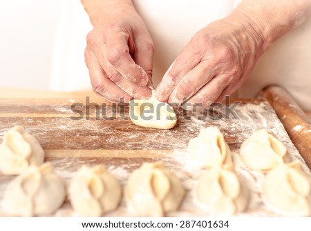 Woman cooks dumplings.