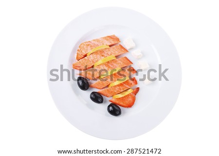 fresh roast wild pink salmon meat fillet with greek goat cheese black olives and raw lemon slices on plate isolated over white background