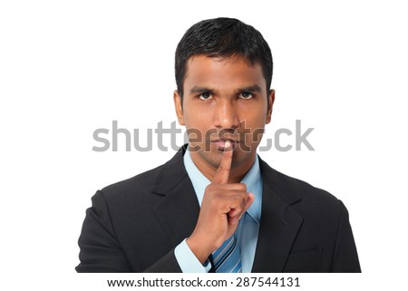 Portrait of businessman asking to keep silence