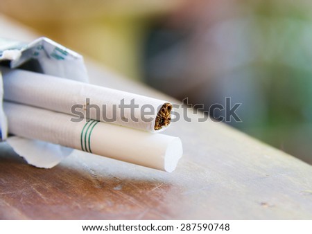 Close up of cigarettes on wooden table