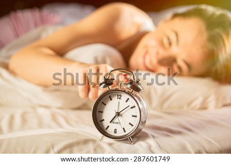 Happy woman waking up in morning Royalty-Free Stock Photo #287601749