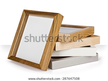stack of wooden photo frames on white background