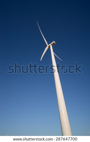 wind turbine against deep blue sky