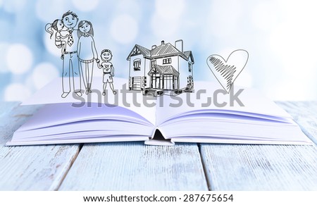 Open book with drawings on light background