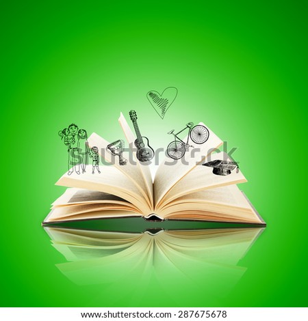 Open book with drawings on green background