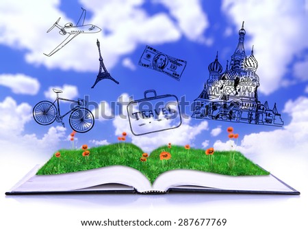Open book with drawings on sky background