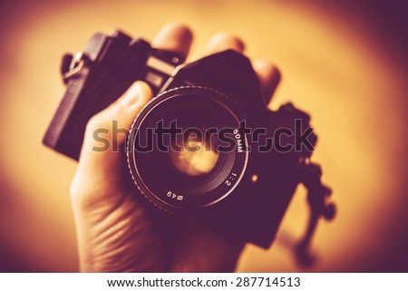 Vintage Photography Concept. Vintage Analog Camera in a Hand.