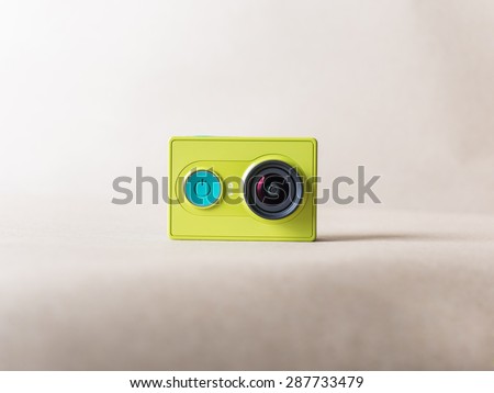 Xiaomi Yi action camera green color on brown paper