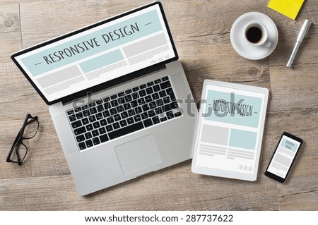 Closeup shot of laptop with digitaltablet and smartphone on desk. Responsive design web page on their screen. Modern devices on desk at office.  Royalty-Free Stock Photo #287737622