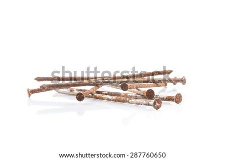 some old rusty nails on white table