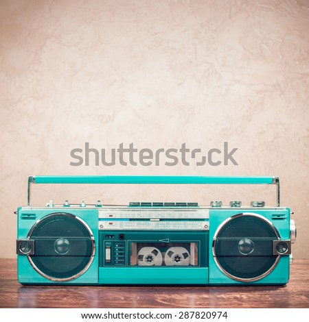 Retro old mint green radio recorder from 80s front grunge background. Vintage style instagram filtered photo