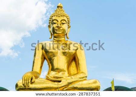 Golden Buddha statue of Big Buddha over blue sky. Chiang rai in thailand.