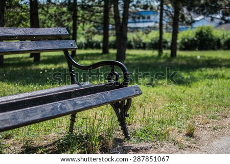 Black iron bench photographed in city park Dudova suma, Serbia. Still in usable condition. Picture taken on nice sunny day 