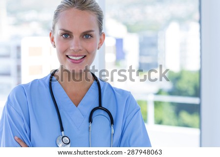 Happy doctor looking at camera in medical office