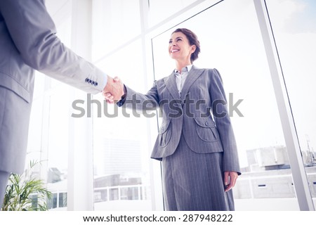 Business colleagues greeting each other in the office