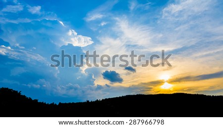 silhouette shot image of mountain and sunset sky  in background.