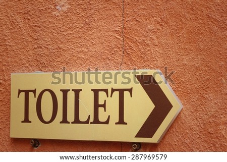 toilet vintage label on a brown background.