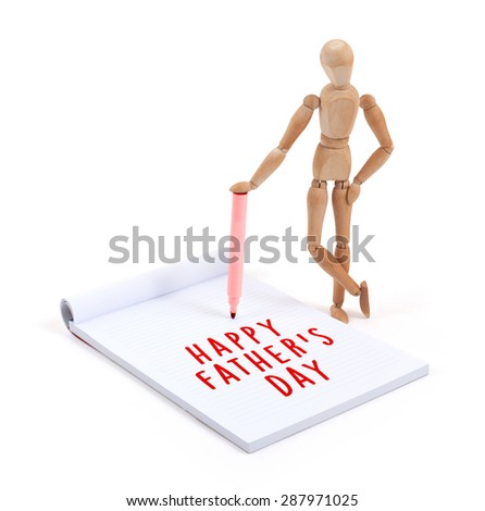 Wooden mannequin writing in a scrapbook - Happy fathers day