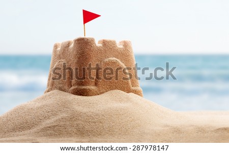 Holiday concept with sandcastle on the seaside Royalty-Free Stock Photo #287978147