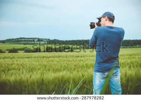Photographer is taking a picture of scenic landscape.