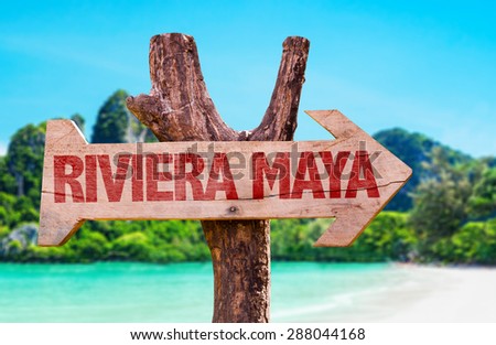 Riviera Maya wooden sign with beach background