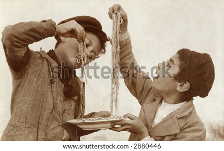 Vintage Photo of two young boys eating spaghetti with their hands