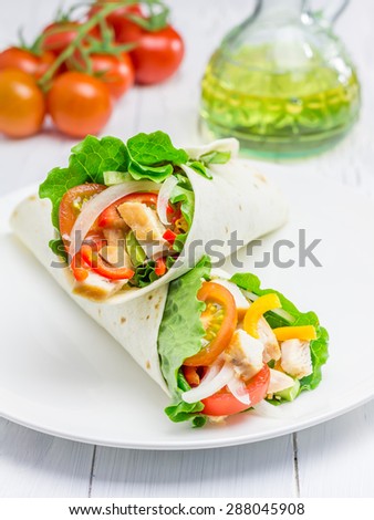 Tortilla wraps with roasted chicken fillet and  fresh vegetables