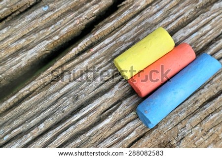 Colored Chalk on old wood background