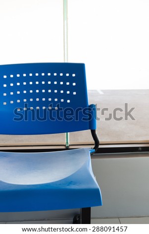 customer waiting area with rows of blue seats in office
