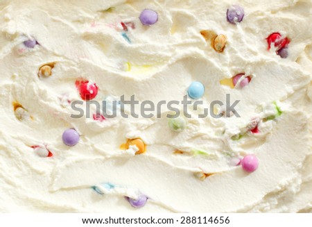 Creamy ice cream with colorful multicolored candy pearls in a full frame background texture for advertising and summer food themed concepts