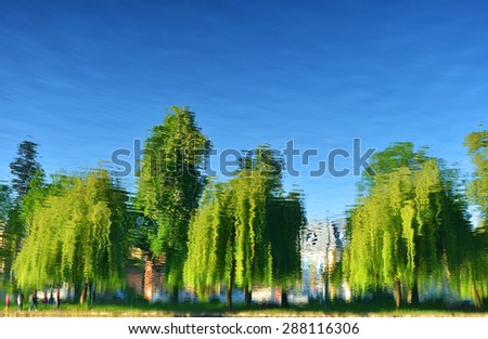 Landscape with trees, reflecting in the water
