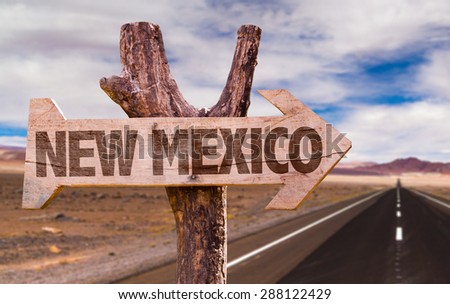 New Mexico wooden sign with desert road background