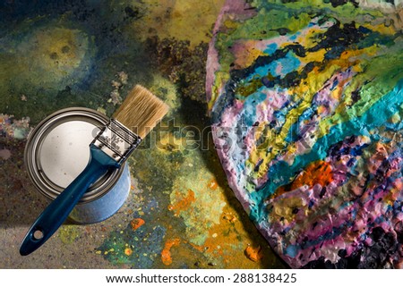 New brush on the iron pot with paint near the palette splashed paint