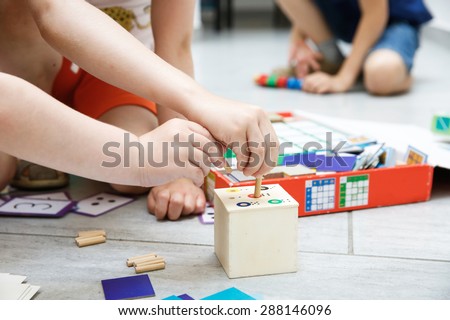 Children playing with homemade, do-it-yourself educational toys. Learning through experience concept.  Royalty-Free Stock Photo #288146096