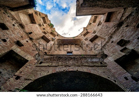 Ruins of Baths of Diocletian, Rome, Italy. Old Baths of Diocletian (Terme di Diocleziano) is landmark of Roma. Bottom view of round courtyard-well of Ancient building, architecture of Roman Empire.
