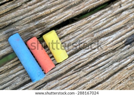 Colored Chalk on old wood background