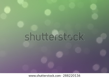 Beautiful defocused LED lights filtered bokeh abstract with purple green tone background.