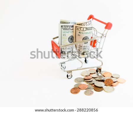 US dollars banknote and coins with shopping cart isolated on white background. Concept of currency, business, finance and online shopping/e-commerce. Copy space.