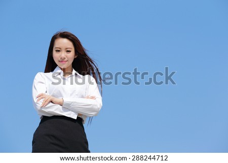 Successful business woman smile to you with blue sky, asian beauty
