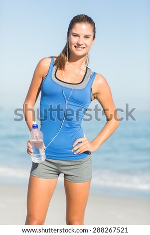Portrait of beautiful fit woman looking at camera at the beach