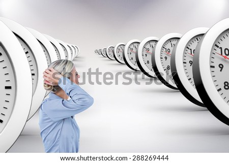 Businesswoman holding her head against grey background