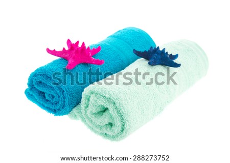 Rolled blue fresh towels with starfishes isolated over white background