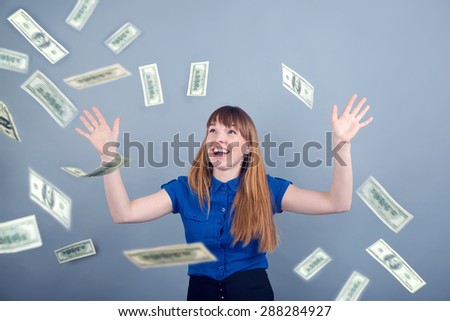 Young woman enjoys the money. Money rain is flying at her. Excited woman under a money rain. Happy woman and rain of dollar USA. woman shouts of joy, because she won a large sum of money. Woman, money