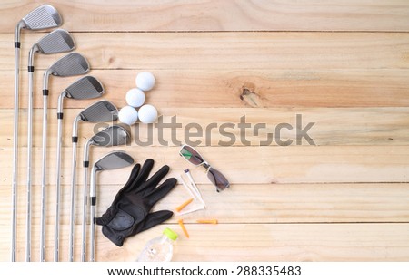 Golf equipment on wood floor preparing for good game 