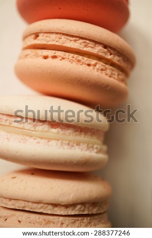 colorful macaroons on white wooden background
