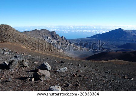 View of Haleakala volcanic crater detailing the red cinders of past eruptions resembling the landscape of the planet Mars
