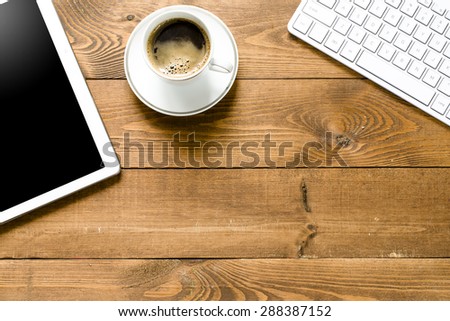 Tablet pc with coffee and keyboard