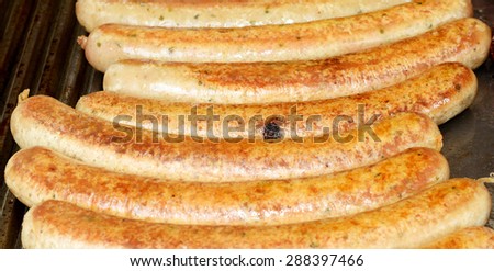 Grilled sausages close-up. Tasty and fragrant sausages. Delicious and flavorful sausages. Common but favorite fast food. Enjoy your meal. Bon appetit. Stock photo.